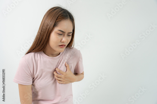 hand hold chest with heart attack symptoms, asian woman have chest pain caused by heart disease, leak, dilatation, enlarged coronary heart, press on the chest with a painful expression photo