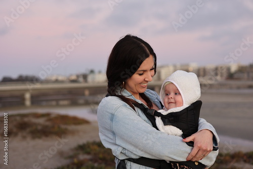 Beautiful Young Mom Holding Baby Girl Outdoors