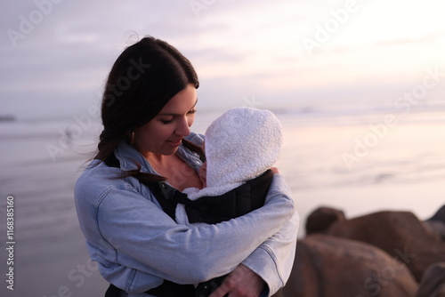 Beautiful Young Mom Holding Baby Girl Outdoors
