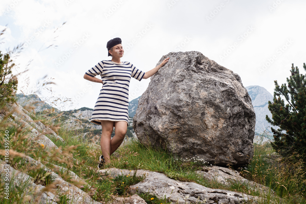 woman in striped dress walk in mountains montenegro durmitor national park