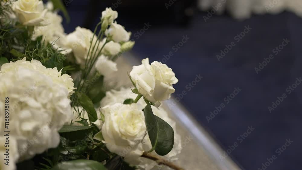 Close up of white roses and greenery in elegant floral arrangement Close up of white roses and greenery in elegant floral arrangement