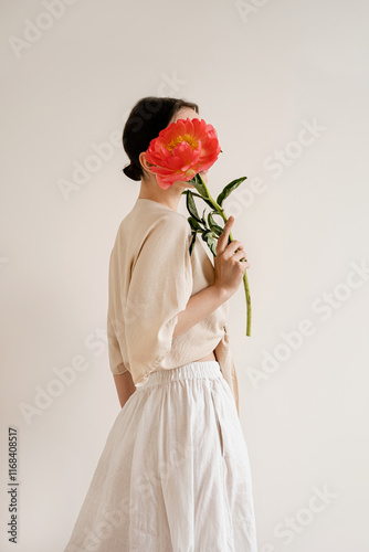 Minimalist Aesthetic. Woman with Peony, Face Obscured, Soft Neutral Tones, Modern Art, Contemporary Fashion