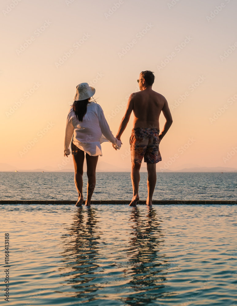 Fototapeta premium Sunset stroll along the tranquil waters of Koh Munnork Island in Rayong, Thailand