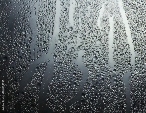 Glass condensation, window steam, water droplets, misted surface, cold weather effect, blurred glass, rainy day atmosphere, condensation droplets, texture, foggy window, wet glass background, moisture
