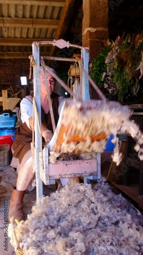 Female Artisan Carding Wool in Traditional Workshop