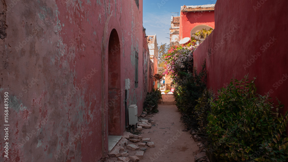 Alley in red color on the famous island of Goree, close to Dakar, known for being the last station of african slaves before being exported to other countries..