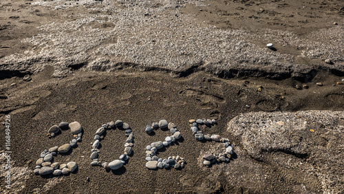 Obraz na płótnie 2025 Written with Stones on Sandy Beach by the Sea w salonie