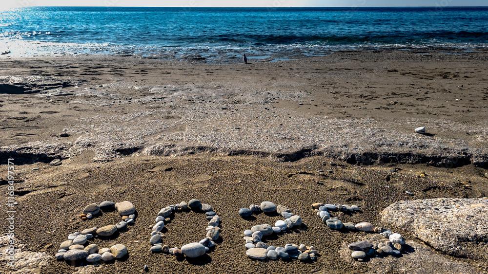 2025 Written with Stones on Sandy Beach by the Sea
