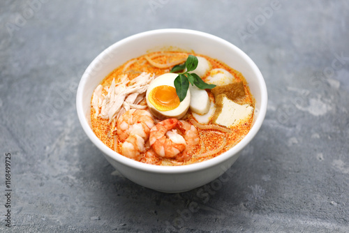 Laksa lemak is a noodle dish from Malaysia and Singapore.
A creamy spicy soup made with a coconut milk base. Common ingredients include shrimp, tofu, boiled eggs, and laksa leaf. 