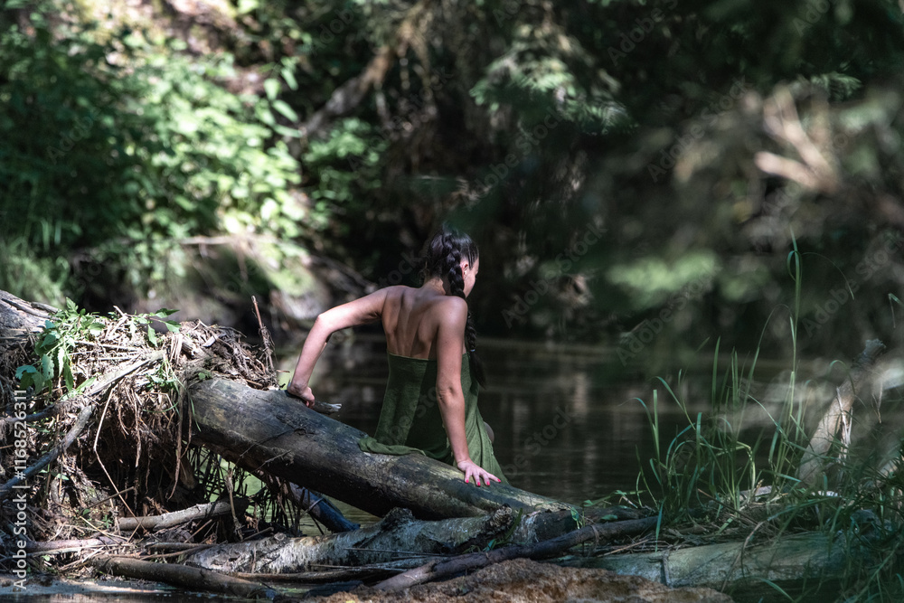 Beautiful young girl posing in a fast forest river in summer. Beautiful young girl posing in a fast forest river in summer.