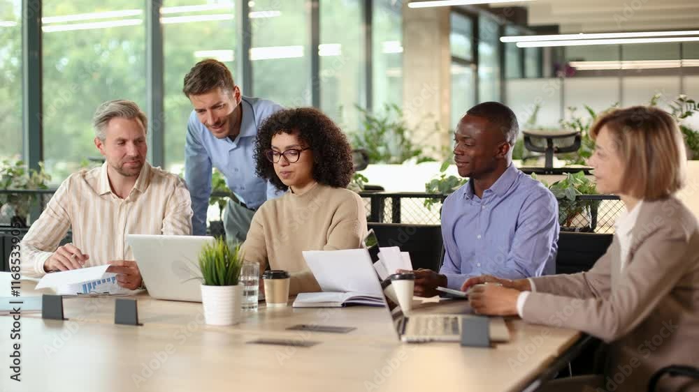 Business people working together on project using laptop in modern office Business people working together on project using laptop in modern office
