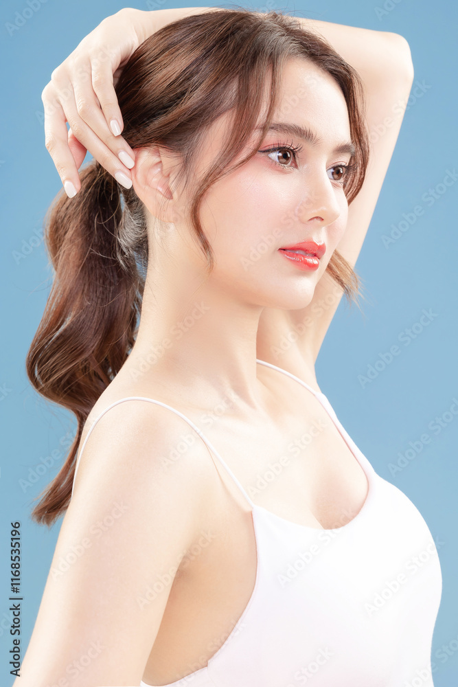 Young Asian beauty woman pull back hair with Koreans makeup style on face and perfect clean skin on isolated blue background. Facial treatment, Cosmetology, plastic surgery. Young Asian beauty woman pull back hair with Koreans makeup style on face and perfect clean skin on isolated blue background. Facial treatment, Cosmetology, plastic surgery.