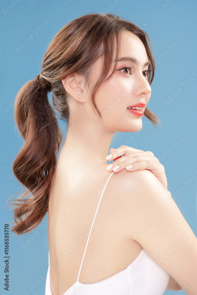 Young Asian beauty woman pull back hair with Koreans makeup style on face and perfect clean skin on isolated blue background. Facial treatment, Cosmetology, plastic surgery. Young Asian beauty woman pull back hair with Koreans makeup style on face and perfect clean skin on isolated blue background. Facial treatment, Cosmetology, plastic surgery.