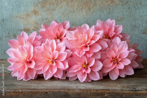 Vibrant pink flowers arranged beautifully on rustic wooden surface