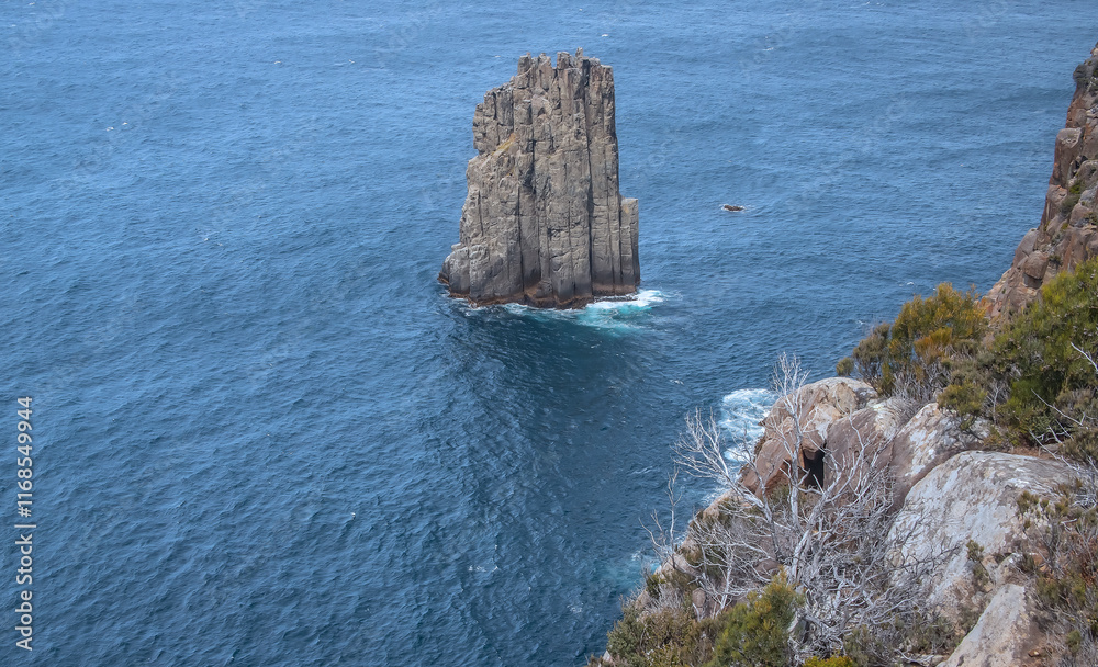 Fototapeta premium Breathtaking view of Cape Hauy Tasmania featuring rugged cliffs lush greenery and the vast ocean. Australia