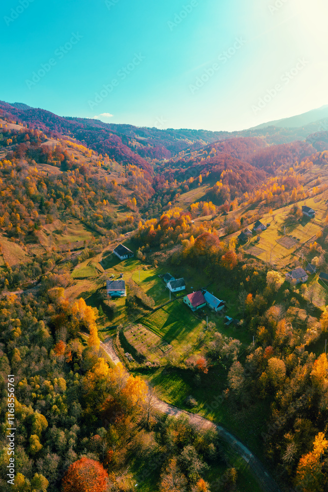 Panoramic view from above of colorful mountain slopes on a sunny autumn day. Beautiful landscape. Carpathian mountains, Kolochava, Ukraine. Vertical photo