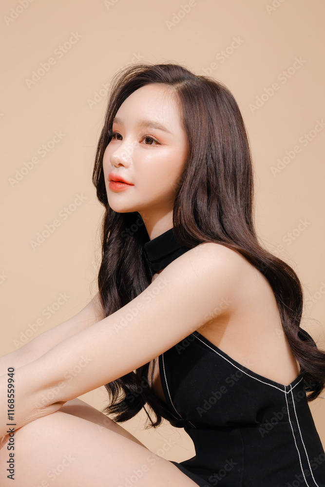 High fashion of perfect slim body beautiful face young elegant woman in black dress on isolated beige background. Portrait of female model in studio. plastic surgery and aesthetic cosmetology. High fashion of perfect slim body beautiful face young elegant woman in black dress on isolated beige background. Portrait of female model in studio. plastic surgery and aesthetic cosmetology.