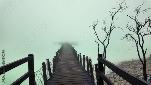 Revealing wooden bridge that seemed endless because it was covered in thick fog