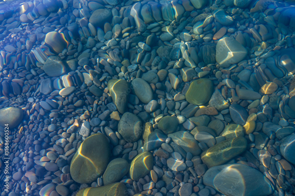 Fototapeta premium Underwater rock with blue green water ripple pattern bottom