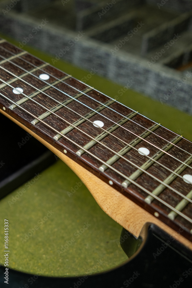detail of the neck and strings of an electric guitar detail of the neck and strings of an electric guitar