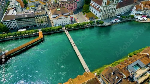 4K Drone Video of the Chapel Bridge and Rathaussteg Bridge crossing the Reuss River near Lake Luzerne in Lucerne, Switzerland photo