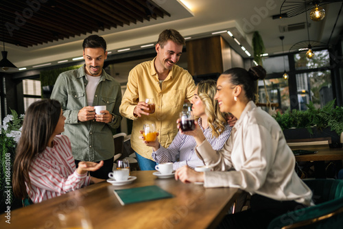 фотографія Two young men approaching a group of women at a café, engaging in friendly conve