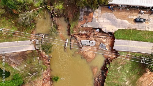 Bridge washed out completely by the flood waters of Hurricane Helene. Drone shot in Swannanoa, NC, near Asheville. photo