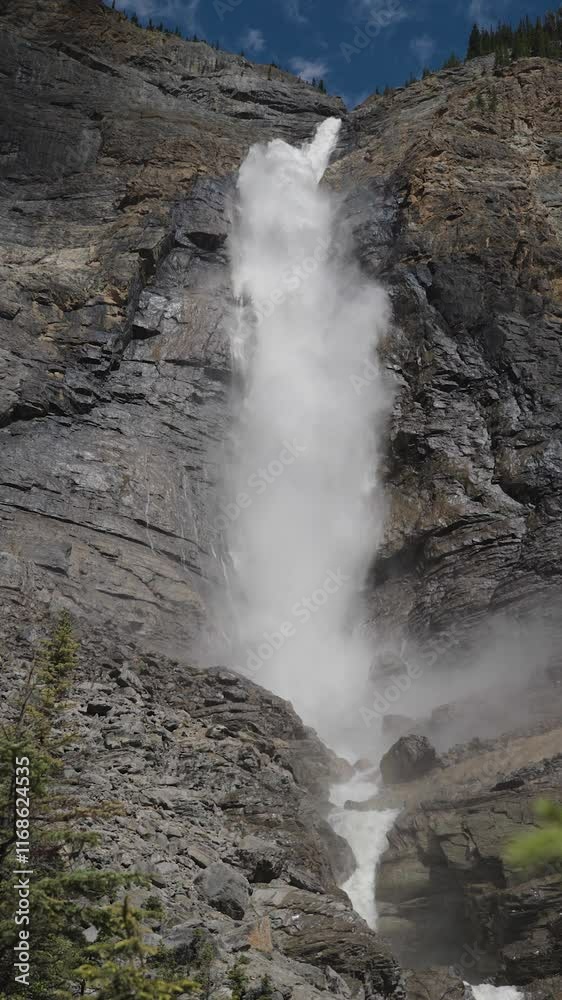 Takakkaw Falls cascading down steep rocky cliffs in a powerful and dramatic display Takakkaw Falls cascading down steep rocky cliffs in a powerful and dramatic display