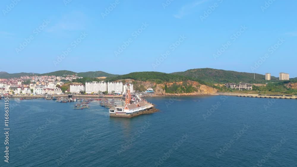 Coastal view showcasing a lively fishing port surrounded by hills and coastal buildings Coastal view showcasing a lively fishing port surrounded by hills and coastal buildings