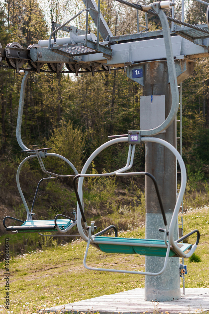 Scenic Ski Lift Chairs Against a Lush Green Landscape in Spring Scenic Ski Lift Chairs Against a Lush Green Landscape in Spring