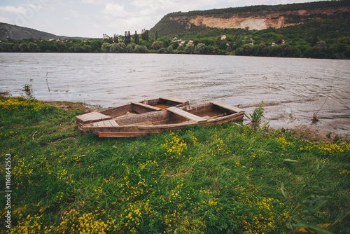 idyllic river scenery with boats. Rustic Fishing Boats .Old wooden dinghy on the shore photo