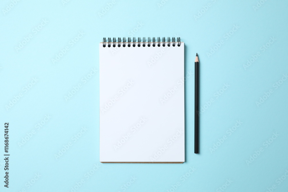 Flat lay with pencil and notebook on color background, top view Flat lay with pencil and notebook on color background, top view