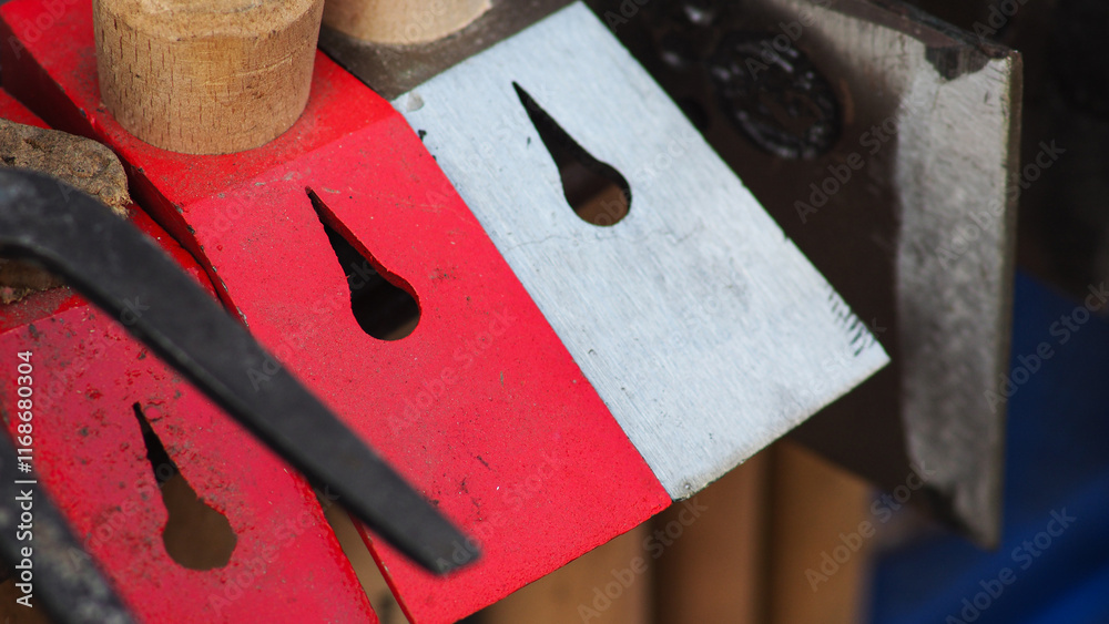 Red and White color Metal logging axe sold on the street Red and White color Metal logging axe sold on the street