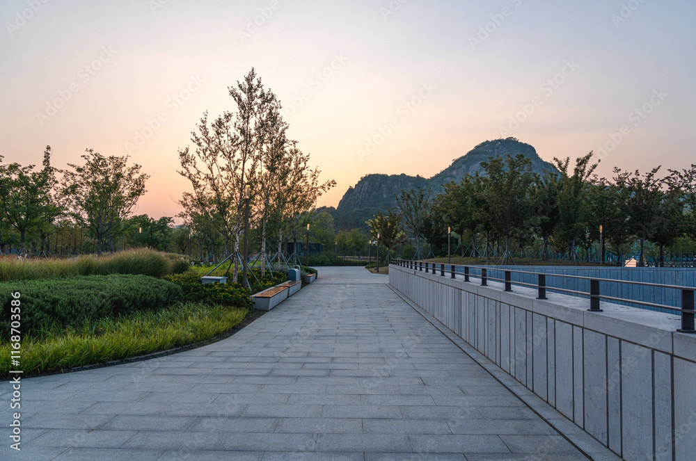 Serene Pathway Through Lush Park at Sunset Serene Pathway Through Lush Park at Sunset