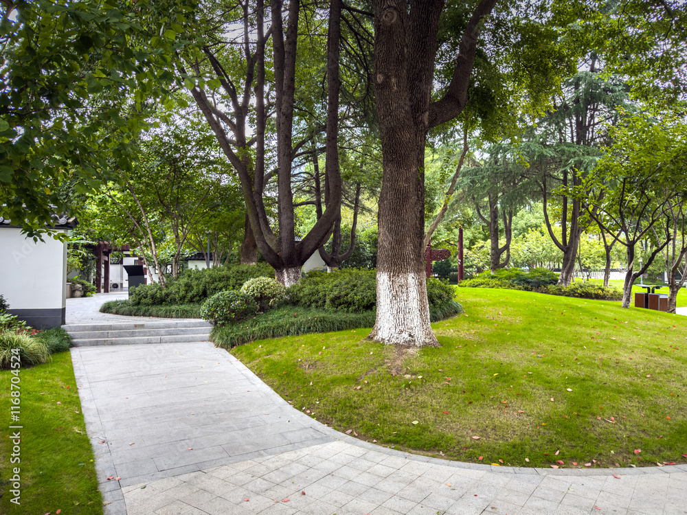 Tranquil Garden Pathway Surrounded by Lush Greenery and Trees Tranquil Garden Pathway Surrounded by Lush Greenery and Trees