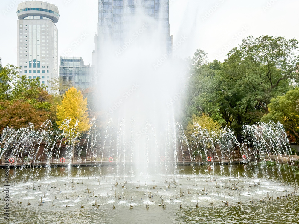 Majestic Fountain Display Surrounded by Lush Greenery in Urban Park