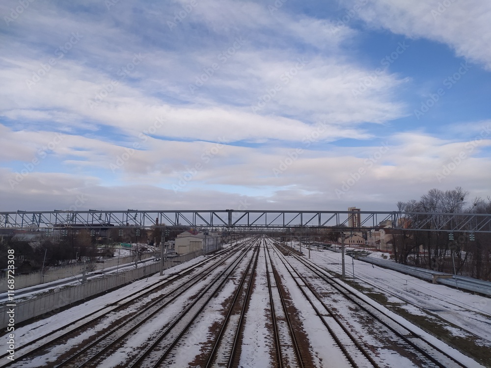 Railway tracks in winter with blue sky and white clouds. Russia Railway tracks in winter with blue sky and white clouds. Russia