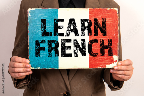 Learn French. French flag in the hands of a business woman