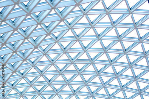 a blue diamond shaped ceiling with a blue sky in the background