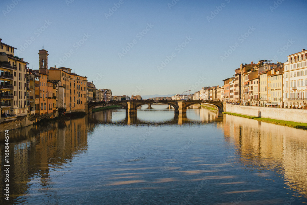 The embankment of the Arno River in Florence. Renaissance architecture. Reflection of houses in the water. Florence Bridge: Ponte Vecchio The embankment of the Arno River in Florence. Renaissance architecture. Reflection of houses in the water. Florence Bridge: Ponte Vecchio