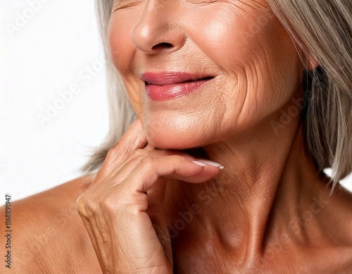 Mujer mayor con piel radiante tocándose el rostro photo