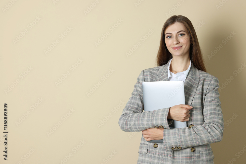 Fototapeta premium Portrait of smiling banker with laptop on beige background. Space for text
