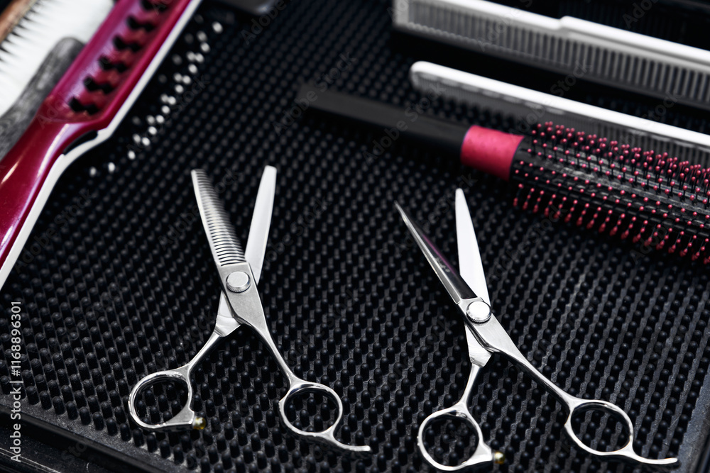 Quality hair scissors and styling tools arranged on a salon table