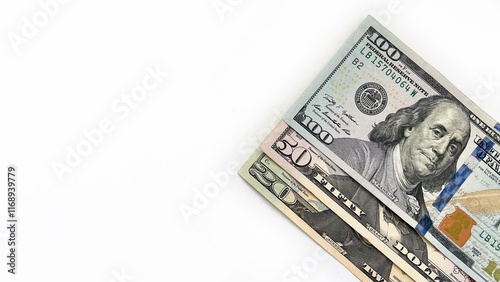 Fotografie Three United States currency notes in denominations of 20 dollar bill, 50 dollar bill, 100 dollar bill, neatly stacked diagonally on a white background