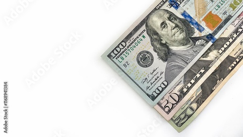 Fotografie Three United States currency notes in denominations of 20 dollar bill, 50 dollar bill, 100 dollar bill, neatly stacked diagonally on a white background