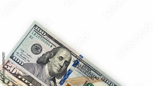 Obraz na plátně Three United States currency notes in denominations of 20 dollar bill, 50 dollar bill, 100 dollar bill, neatly stacked diagonally on a white background