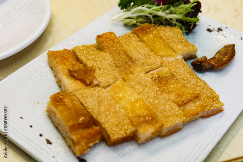 Close up of Chinese Cantonese style crispy boneless chicken with stuffed minced shrimp with sesame on top and cut into pieces  photo