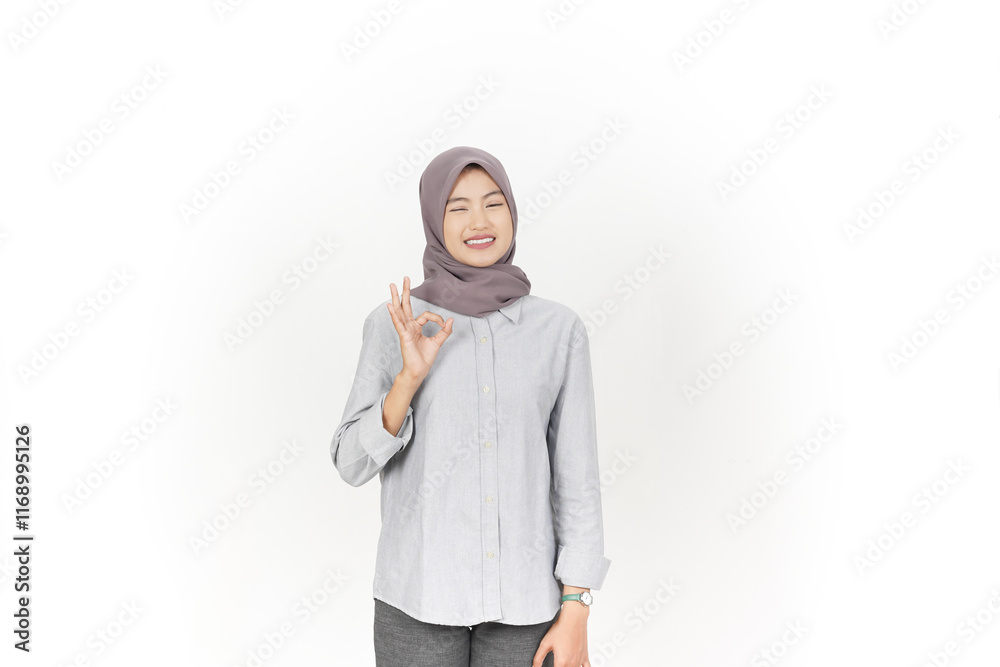 Smiling and showing okay sign, Approve sign Of Beautiful Asian Woman wearing hijab Isolated On White Background Smiling and showing okay sign, Approve sign Of Beautiful Asian Woman wearing hijab Isolated On White Background