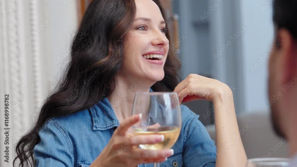 Woman in a blue shirt thoughtfully enjoys a drink at a cafe in the afternoon Woman in a blue shirt thoughtfully enjoys a drink at a cafe in the afternoon