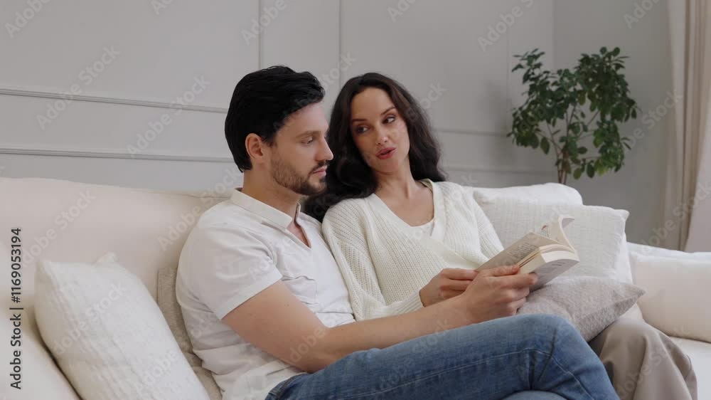 Couple enjoying a quiet reading time together on a cozy sofa at home Couple enjoying a quiet reading time together on a cozy sofa at home